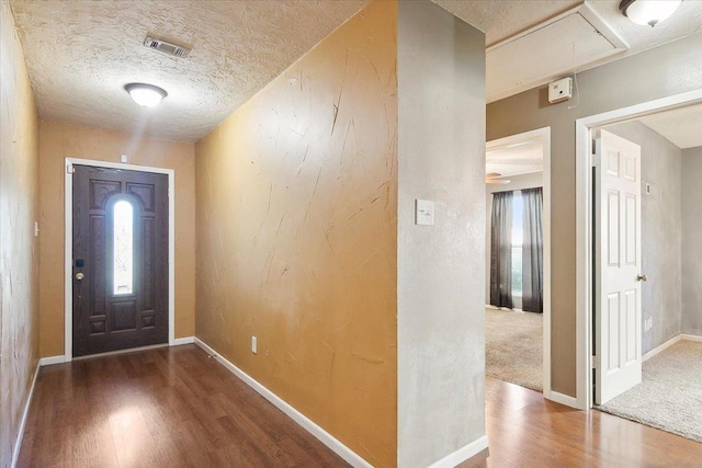 entrance foyer featuring wood-type flooring and a textured ceiling