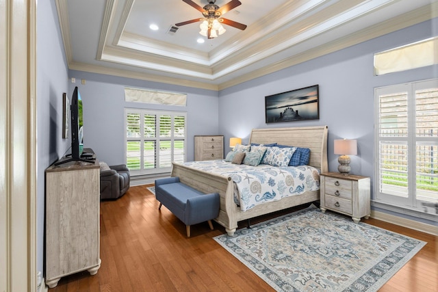 7675 Myrtle Beach Dr, Beaumont, TX 77707 - bedroom featuring ornamental molding, a raised ceiling, wood finished floors, and ceiling fan