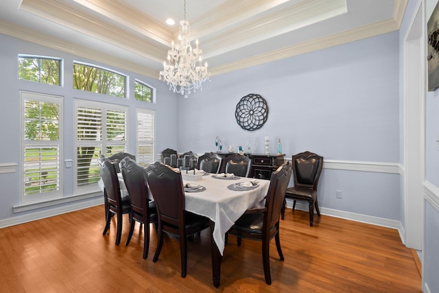 7675 Myrtle Beach Dr, Beaumont, TX 77707 - dining space with a raised ceiling, ornamental molding, a chandelier, and wood finished floors