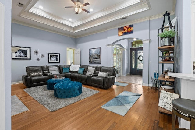 7675 Myrtle Beach Dr, Beaumont, TX 77707 - living area featuring ornate columns, a raised ceiling, ornamental molding, a ceiling fan, and wood finished floors