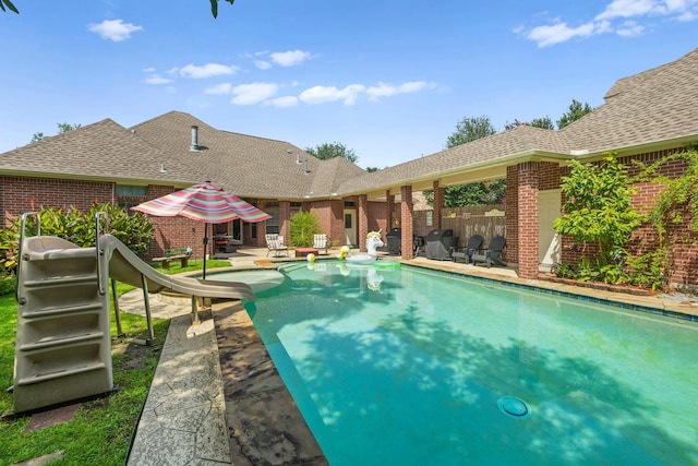 7675 Myrtle Beach Dr, Beaumont, TX 77707 - view of pool with a water slide and a patio area