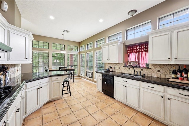 1416 23rd St, Nederland, TX 77627 - kitchen featuring tasteful backsplash, recessed lighting, light tile patterned floors, black appliances, and a peninsula
