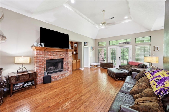 1416 23rd St, Nederland, TX 77627 - living room featuring a ceiling fan, wood-type flooring, a brick fireplace, recessed lighting, and a tray ceiling