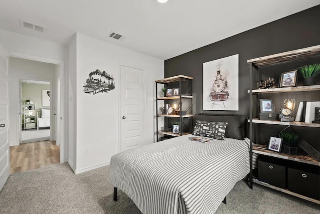 carpeted bedroom with baseboards and visible vents