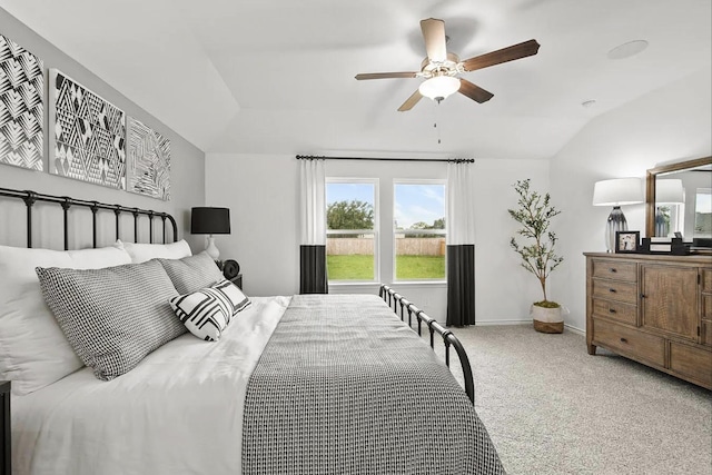 carpeted bedroom with baseboards, ceiling fan, and vaulted ceiling