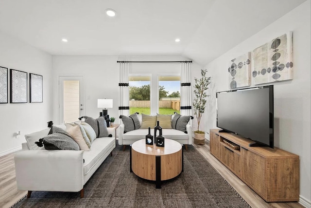 living area with recessed lighting, baseboards, lofted ceiling, and wood finished floors