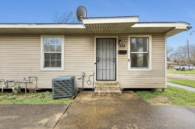 property entrance with central AC unit