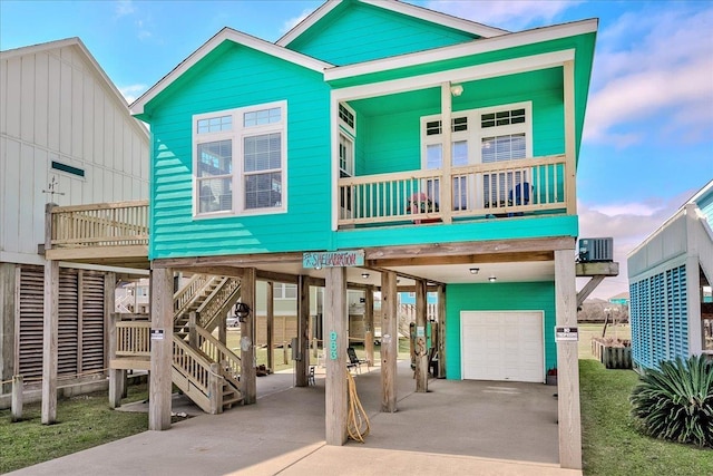 view of front facade featuring a carport, a balcony, and a garage