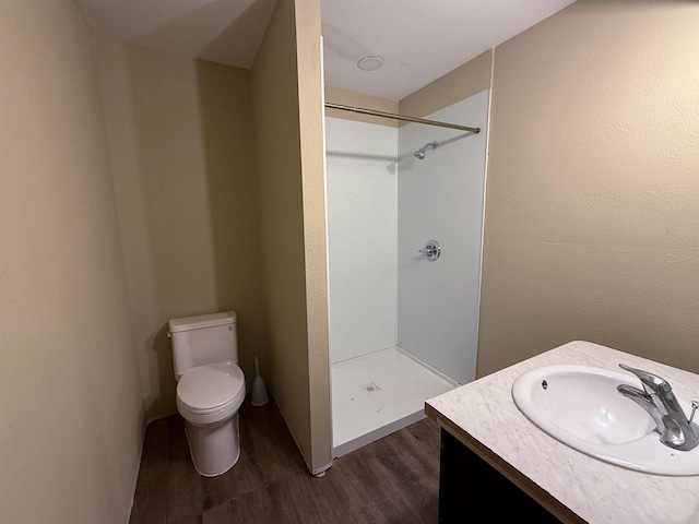 445 Longmeadow, Beaumont, TX 77707 - bathroom featuring wood finished floors, walk in shower, and vanity