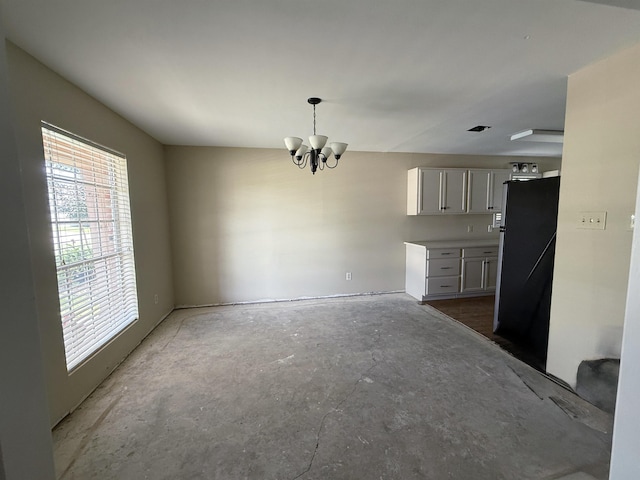 445 Longmeadow, Beaumont, TX 77707 - unfurnished dining area featuring a chandelier and healthy amount of natural light