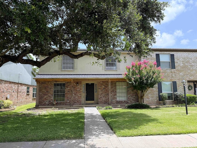 445 Longmeadow, Beaumont, TX 77707 - traditional-style house featuring a front yard and brick siding