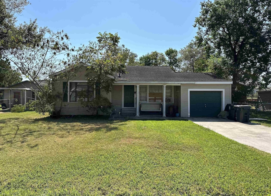 ranch-style house with a garage and a front lawn