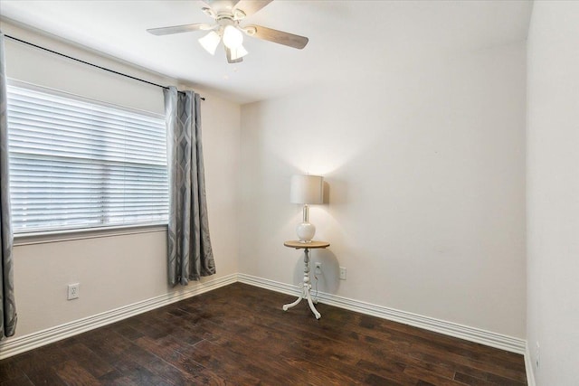 spare room with dark hardwood / wood-style flooring and ceiling fan