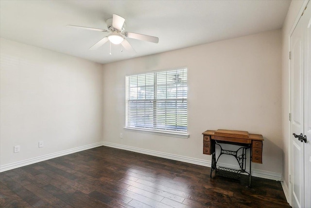 empty room with dark hardwood / wood-style flooring and ceiling fan