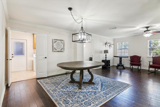 interior space featuring dark hardwood / wood-style flooring, ceiling fan with notable chandelier, and ornamental molding