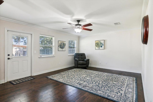 unfurnished room with crown molding, ceiling fan, and dark wood-type flooring