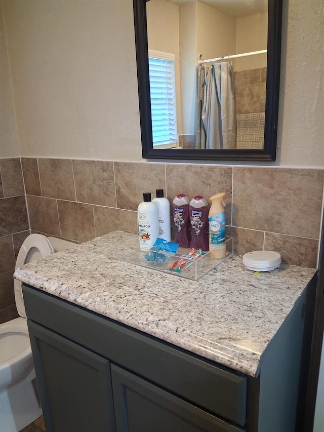 5330 Landry Ln, Beaumont, TX 77708 - full bath with vanity, tile walls, a shower with curtain, and toilet