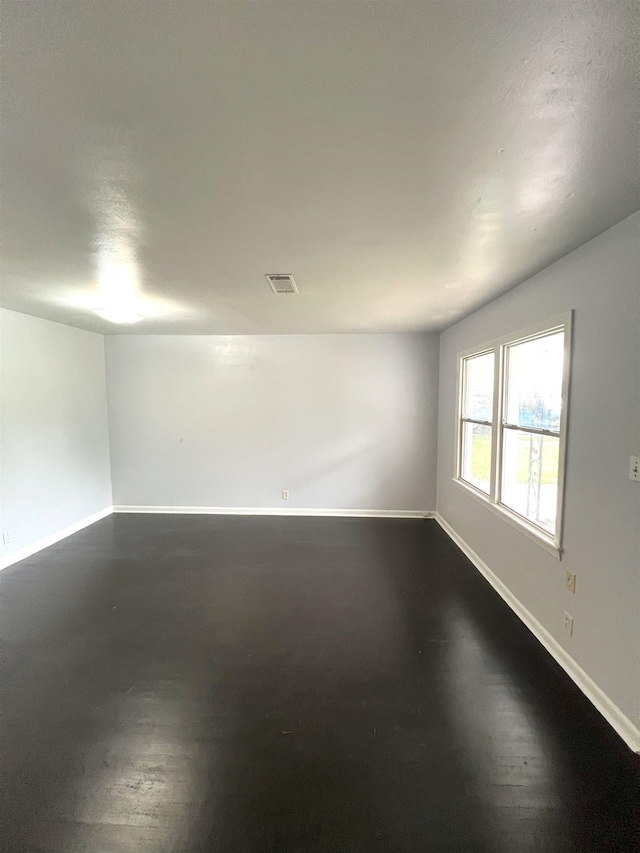 spare room with visible vents and baseboards