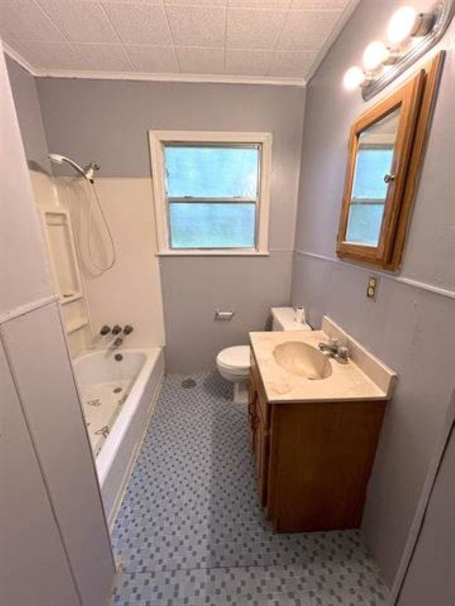 full bathroom with toilet, washtub / shower combination, vanity, and a healthy amount of sunlight