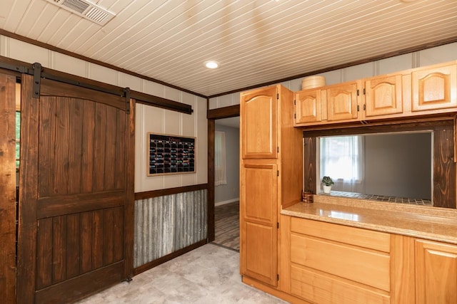 410 Creekwood St, Vidor, TX 77662 - kitchen featuring a barn door, wooden ceiling, light stone counters, and light brown cabinets