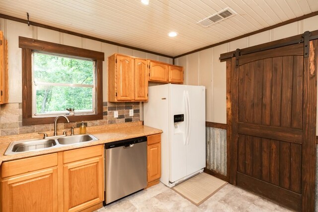 410 Creekwood St, Vidor, TX 77662 - kitchen with dishwasher, a barn door, white fridge with ice dispenser, a sink, and light countertops