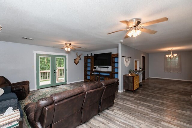 410 Creekwood St, Vidor, TX 77662 - living room with a ceiling fan, a chandelier, wood finished floors, baseboards, and french doors