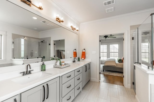 bathroom featuring an enclosed shower, ornamental molding, and vanity