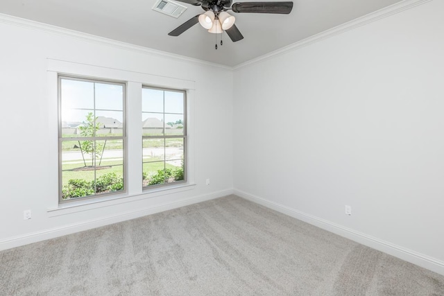 unfurnished room with crown molding, light carpet, and ceiling fan