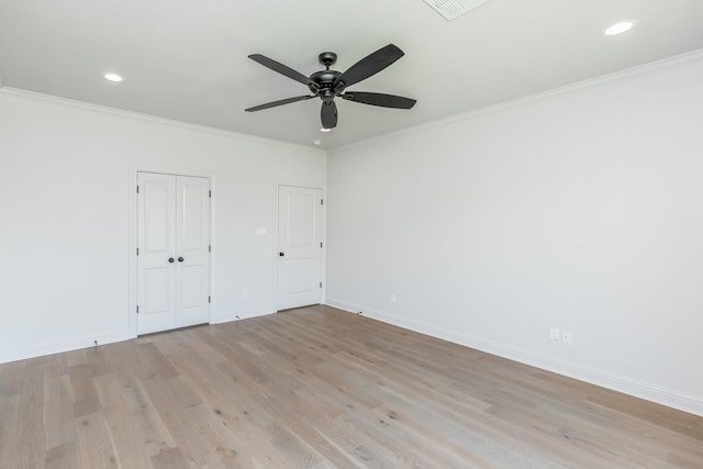 unfurnished bedroom with ceiling fan, ornamental molding, and light wood-type flooring