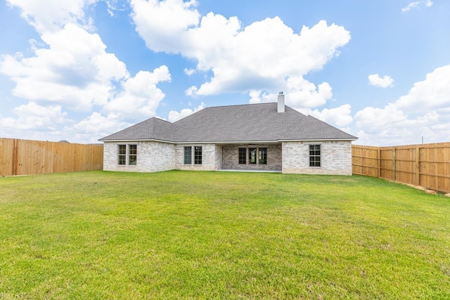 rear view of house with a lawn