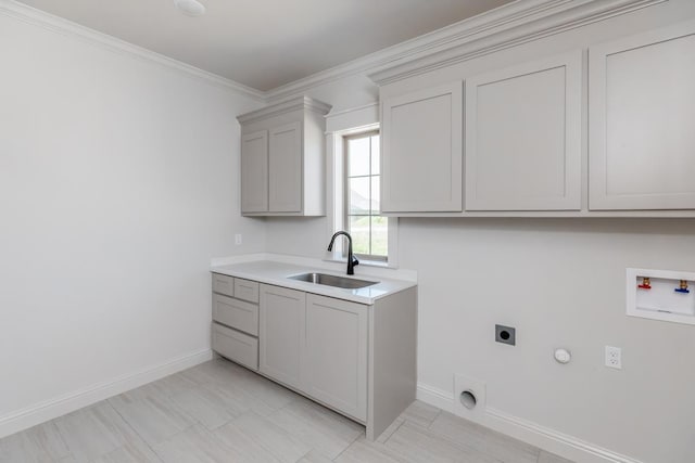 laundry room with sink, crown molding, cabinets, washer hookup, and hookup for an electric dryer