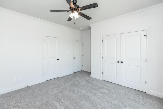 unfurnished bedroom with crown molding, light colored carpet, and ceiling fan