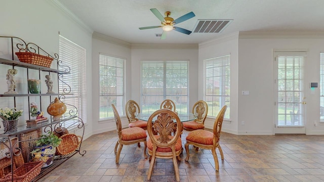 dining space with a healthy amount of sunlight, stone tile floors, a ceiling fan, and visible vents