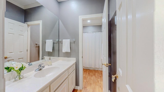 full bathroom featuring wood finished floors and vanity