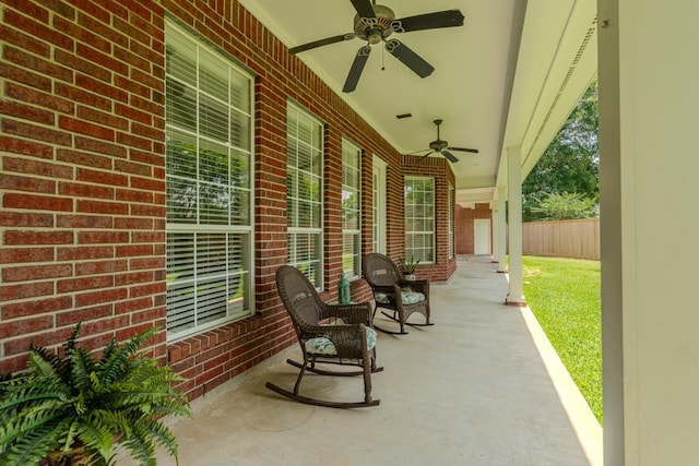 view of patio / terrace with a ceiling fan and fence
