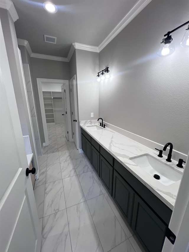 full bathroom with marble finish floor, double vanity, a sink, and crown molding