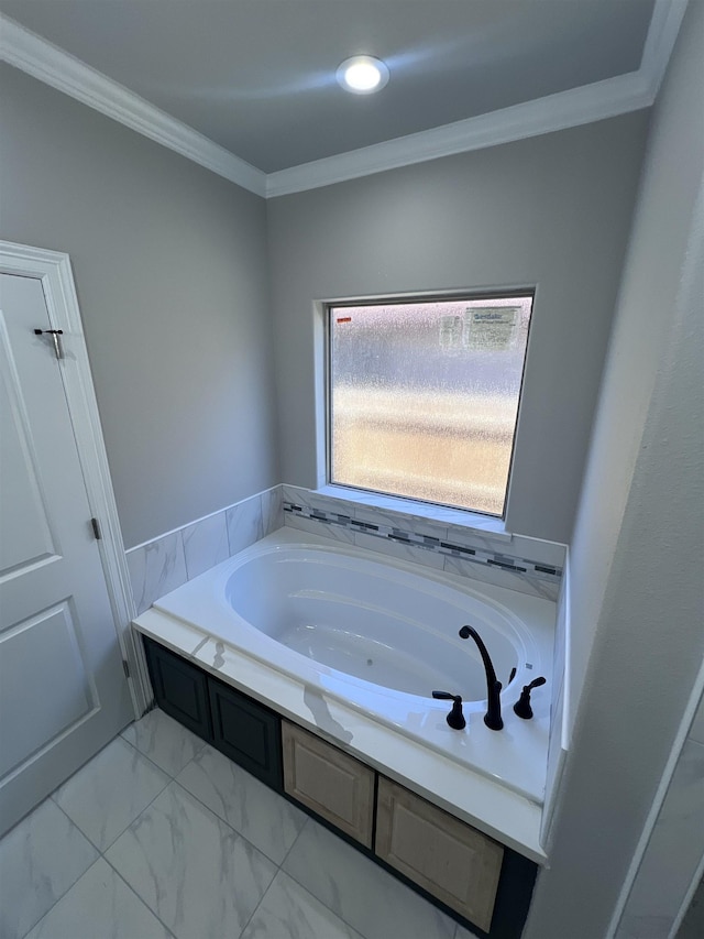 bathroom featuring marble finish floor, ornamental molding, and a bath