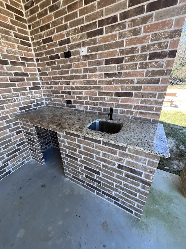 exterior details with brick siding and a sink