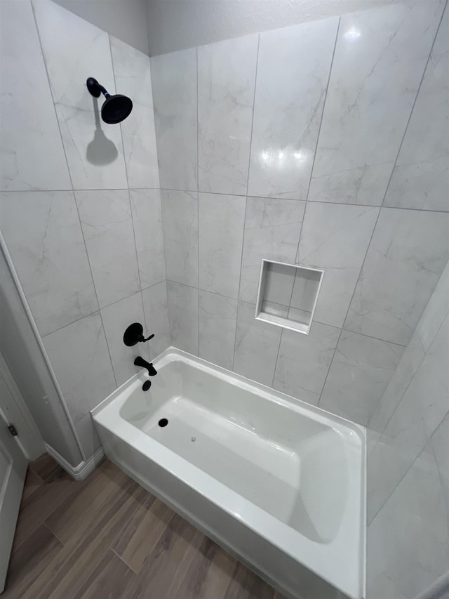 full bath featuring bathtub / shower combination and wood finished floors