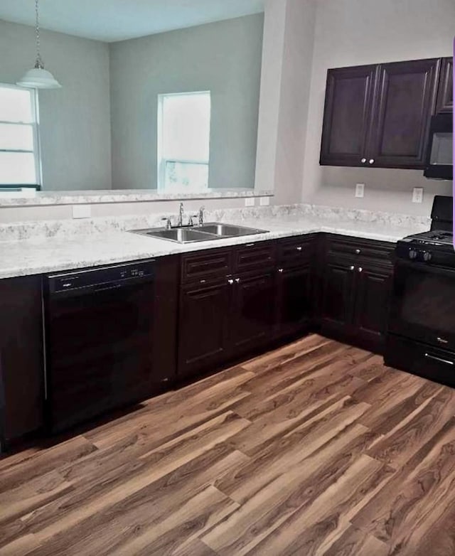 kitchen featuring wood-type flooring, sink, dark brown cabinets, and black appliances