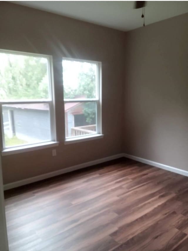 spare room with dark hardwood / wood-style floors