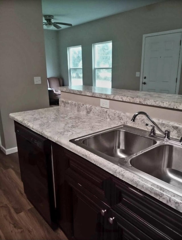 kitchen featuring dark brown cabinetry, ceiling fan, sink, dark wood-type flooring, and black dishwasher