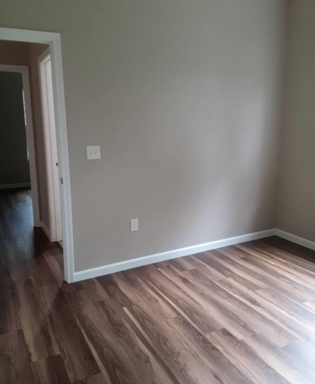 empty room featuring dark hardwood / wood-style floors