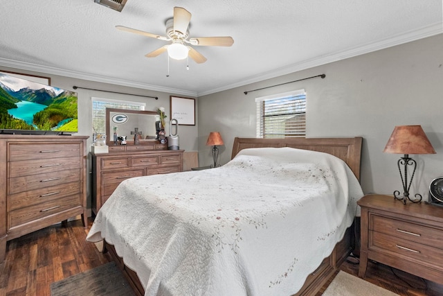 bedroom featuring dark wood finished floors, a textured ceiling, a ceiling fan, and ornamental molding