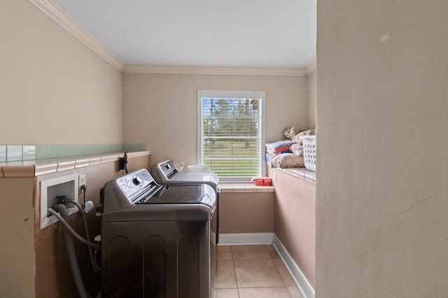 washroom with light tile patterned floors, crown molding, laundry area, and washer and clothes dryer