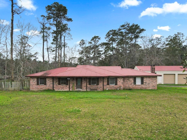 ranch-style house with a chimney, fence, a front lawn, and metal roof