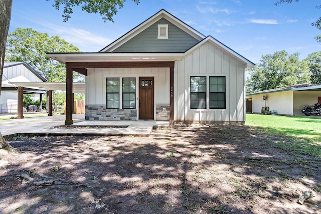 4450 W Brown St, Orange, TX 77630 - modern farmhouse with covered porch, board and batten siding, a carport, and stone siding