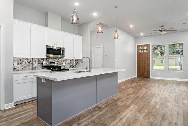 4450 W Brown St, Orange, TX 77630 - kitchen with appliances with stainless steel finishes, a sink, backsplash, a ceiling fan, and light countertops