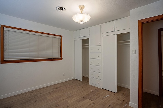 unfurnished bedroom featuring light wood-type flooring