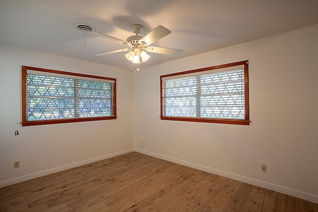 empty room featuring wood-type flooring and ceiling fan